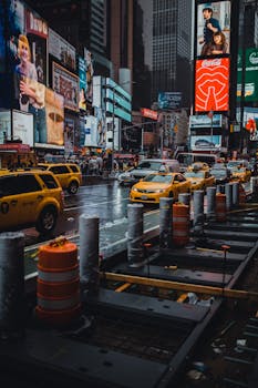 雨天，黄色的出租车和明亮的广告牌照亮了时代广场，展现了城市生活