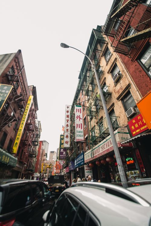 Free Vibrant cityscape of Chinatown with traffic and bustling businesses. Stock Photo