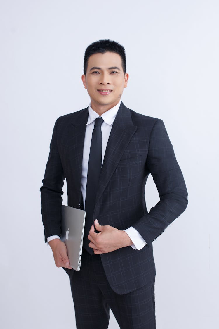 Elegant Businessman Holding Laptop