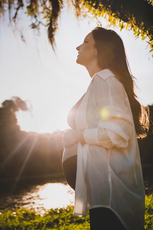 Pregnant Woman Standing in a Park 