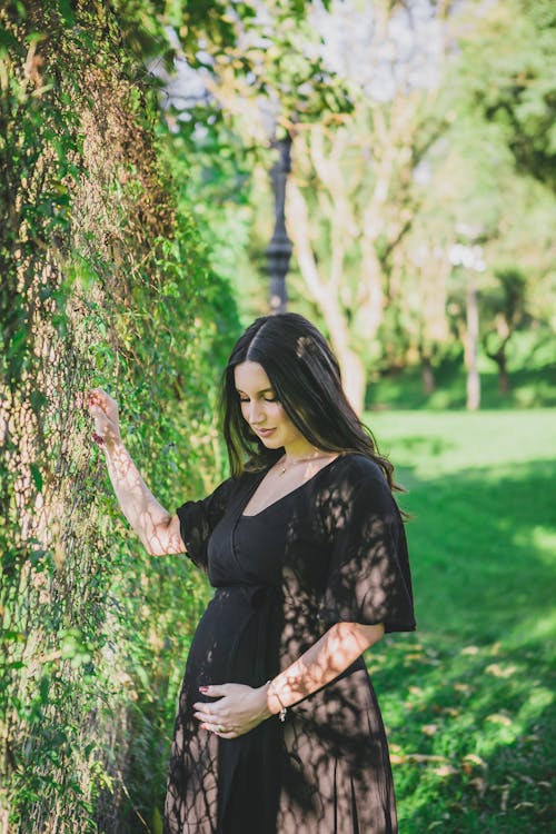 Pregnant Brunette in Park