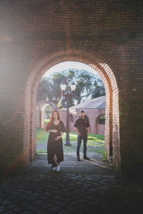 Woman and Man Posing in Fortification Gate