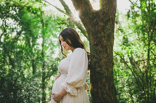 Pregnant Woman on a Walk in the Forest