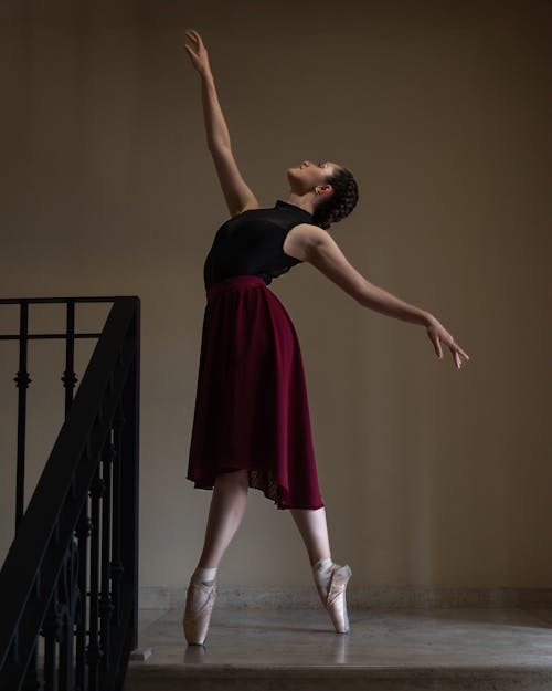 A Ballerina in a Ballet Pose on a Staircase 