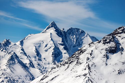 Free Breathtaking view of snow-covered mountain peaks under a clear blue sky, capturing the essence of winter's beauty. Stock Photo