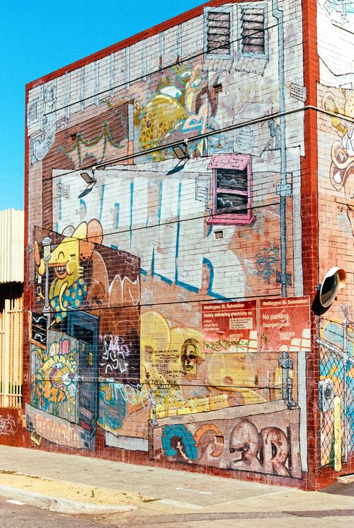Free Colorful street mural on a building in Perth featuring graffiti and urban art elements. Stock Photo