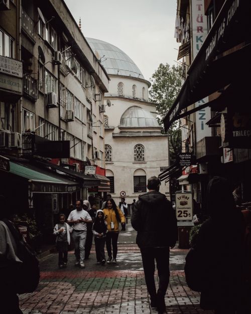 Free A rainy street in Istanbul with people walking and historic architecture in the background. Stock Photo