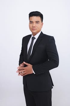 Professional portrait of a confident businessman in a black suit, suitable for corporate purposes.