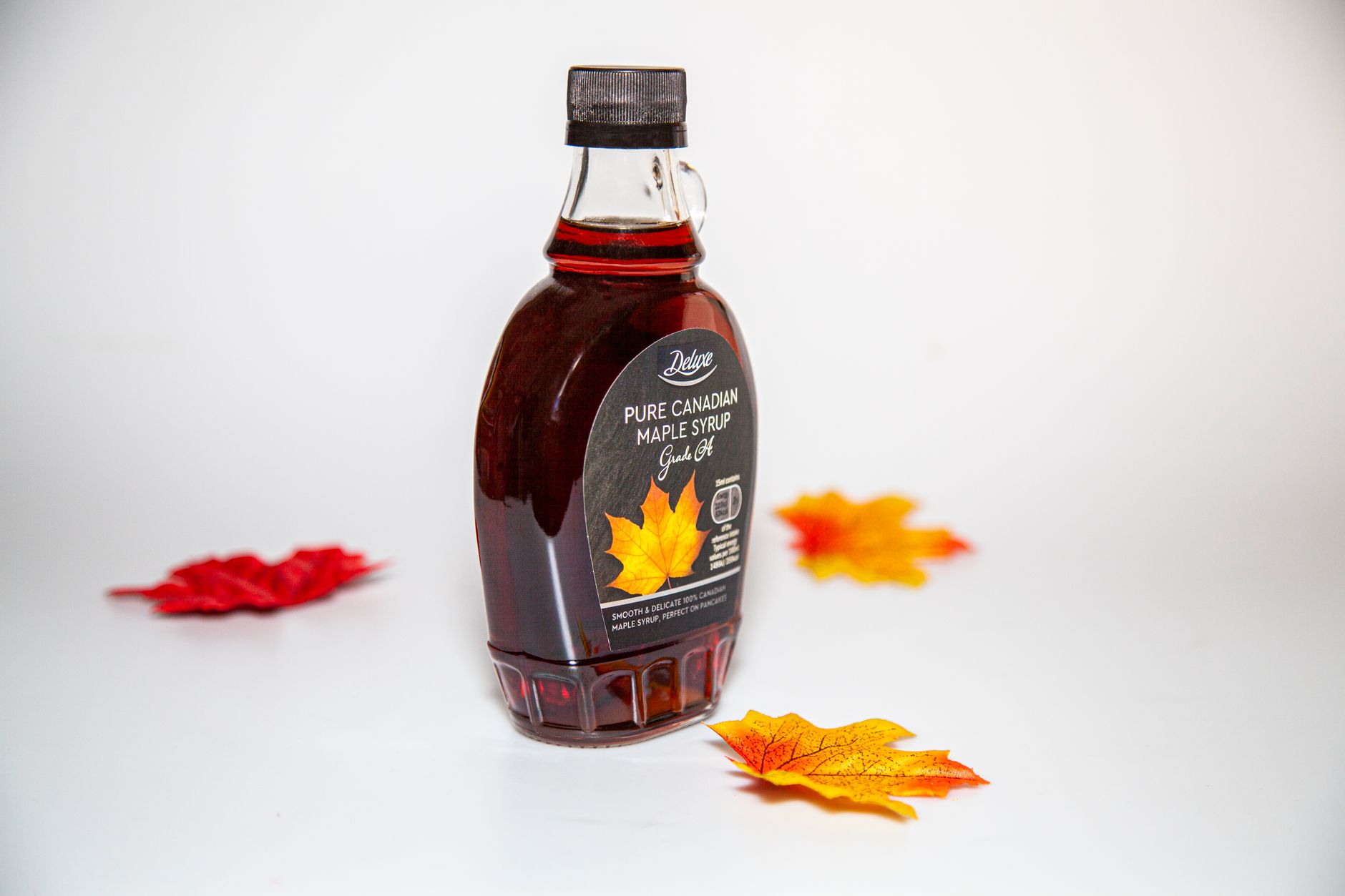 Artisan maple syrup jars displayed on wooden table