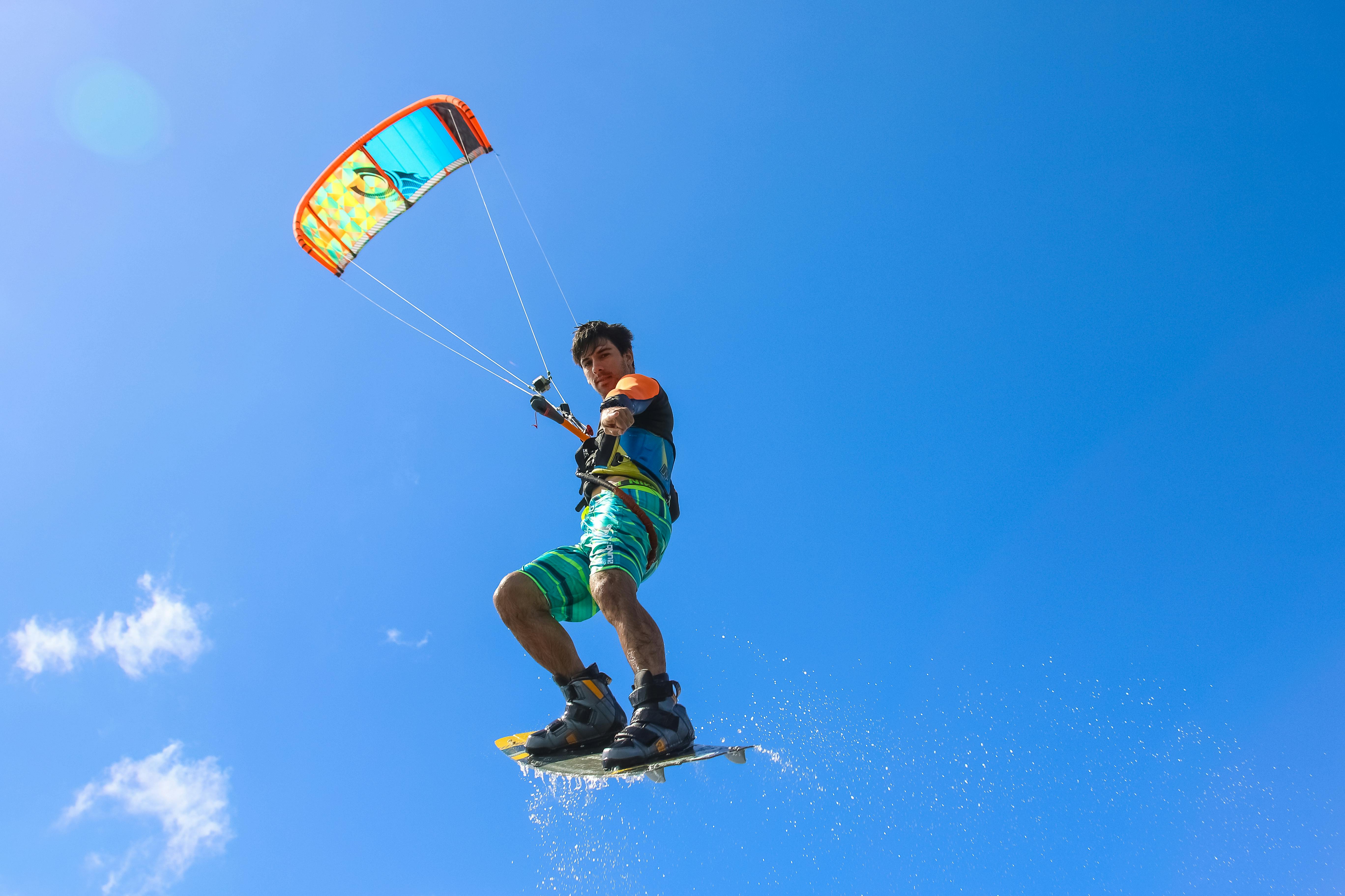 Photo of Pointing Man Kitesurfing · Free Stock Photo