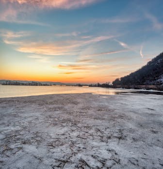 Stunning sunset over a frozen lake in Minneiska, Minnesota, showcasing nature's winter beauty.