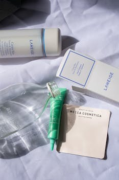 Discover a stylish flat lay of premium skincare products on a soft white fabric for a clean, modern look.