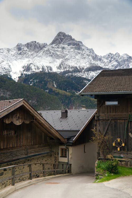 Rural Buildings and Snowcapped Mountains in the Distance 