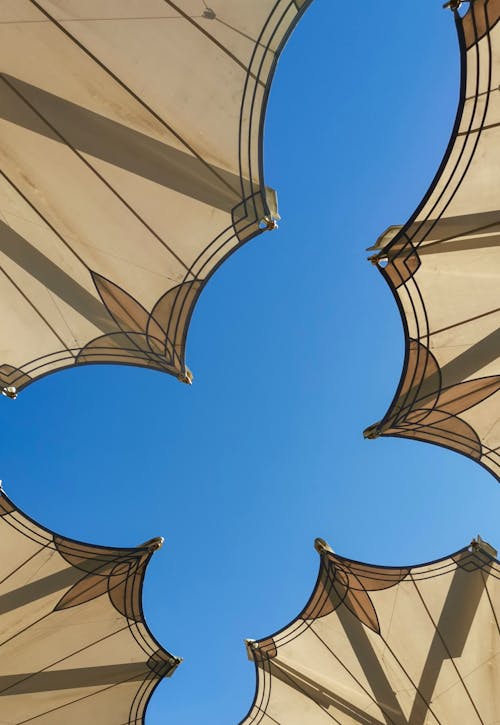 Clear Blue Sky Seen from under Street Cafe Umbrellas