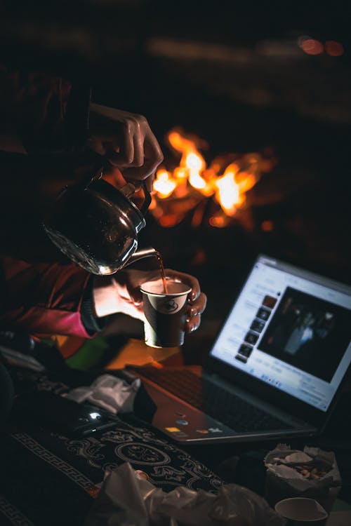 Free Pouring Coffee to Cup on Camping Stock Photo