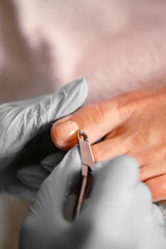Close-up of a professional pedicure treatment using cuticle tongs