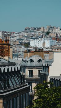 Explore the classic architecture and skyline of Paris from above, showcasing the city's iconic rooftops and urban landscape.