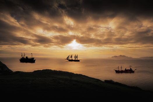 Captivating view of pirate ships silhouetted against a dramatic sunset over the sea.