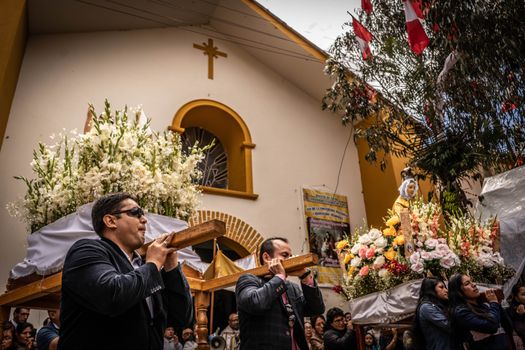 A vibrant religious procession in Tapo, Peru, showcasing local culture and spiritual devotion.