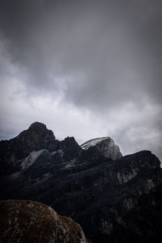 Majestic mountains beneath heavy clouds in Yanec, Junín, Perú, showcasing rugged natural beauty.