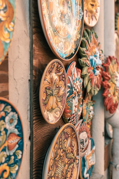 Free Vibrant handcrafted ceramic plates with intricate designs hanging on a wall. Stock Photo