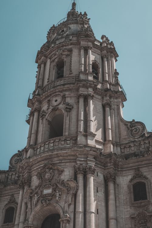 Free Low angle view of an ornate historic Catholic church facade with intricate details. Stock Photo