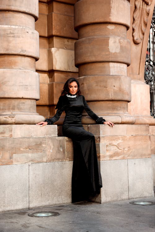 Woman in Black Dress Posing by Wall