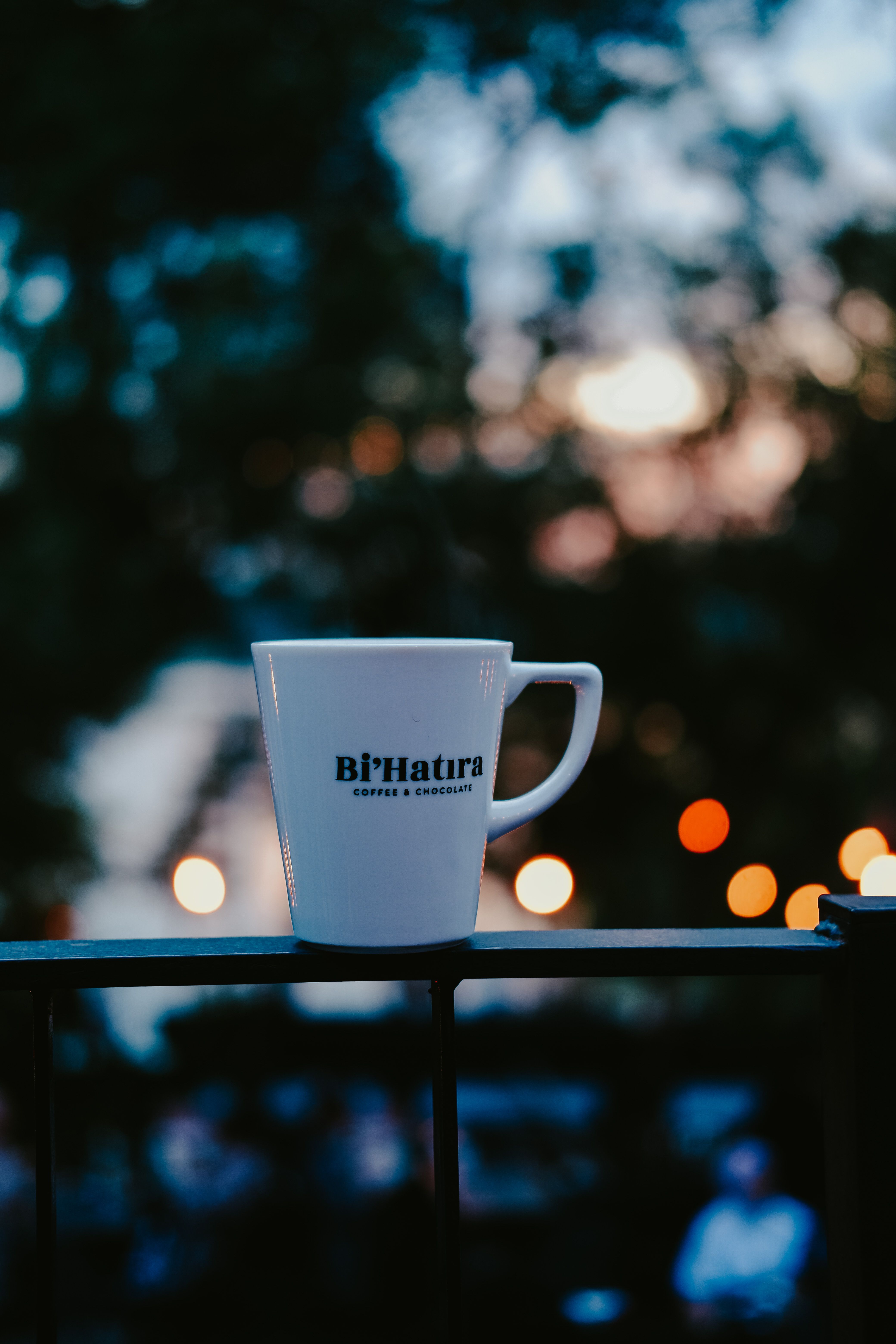 White Ceramic Coffee Cup Standing on Metal Railing · Free Stock Photo