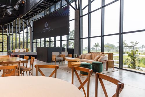 Free Spacious conference hall featuring modern furniture and large windows with a scenic outdoor view. Stock Photo