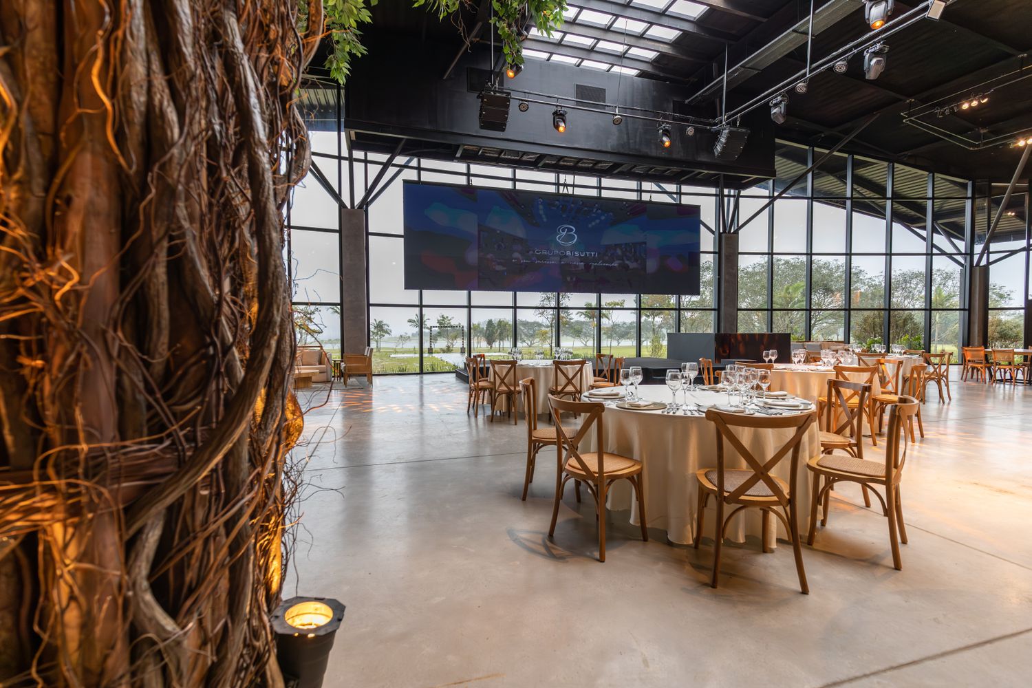 Corporate gala dinner hall with round tables and presentation screen