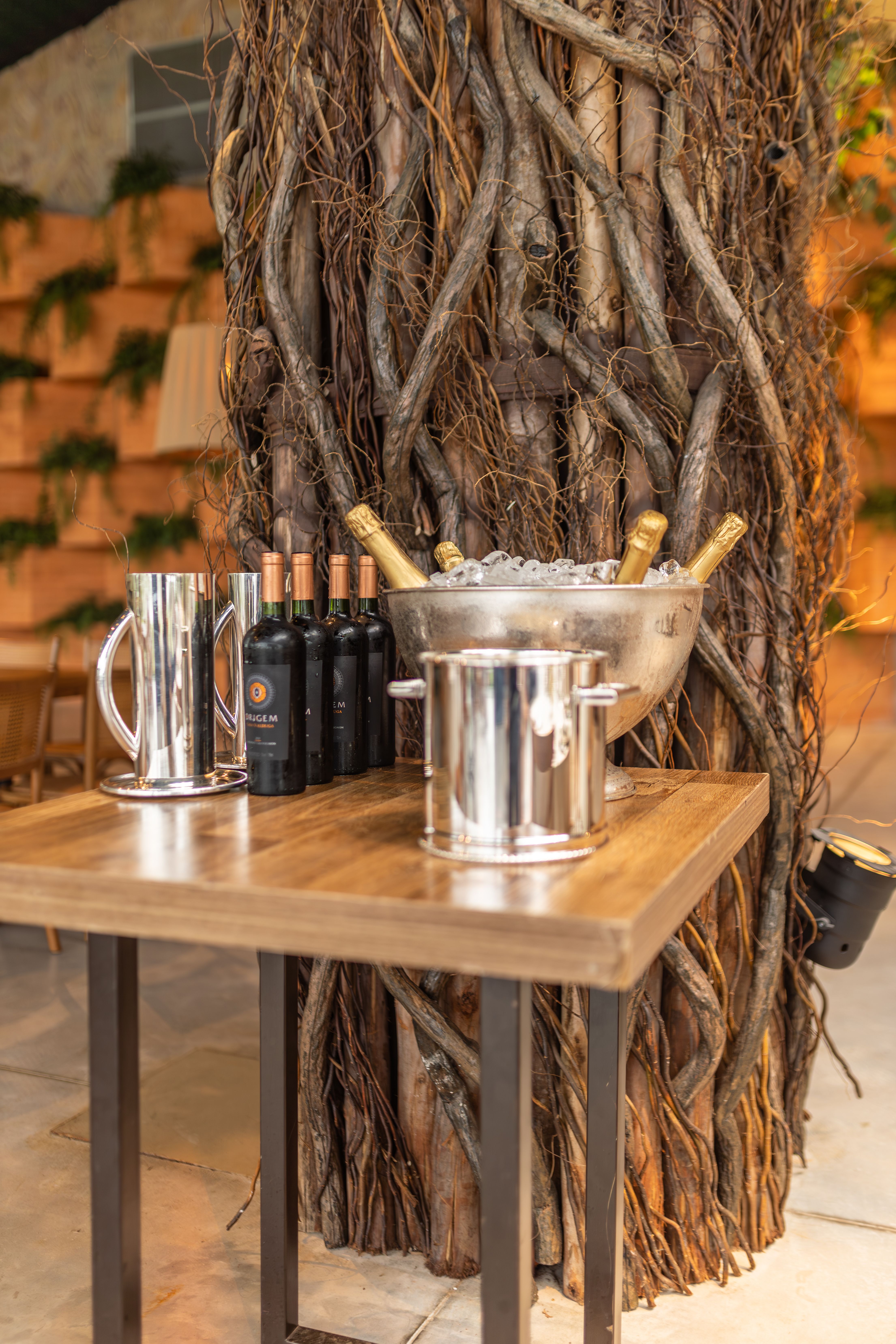 Elegant setup with wine and champagne on wooden table, perfect for celebrations.