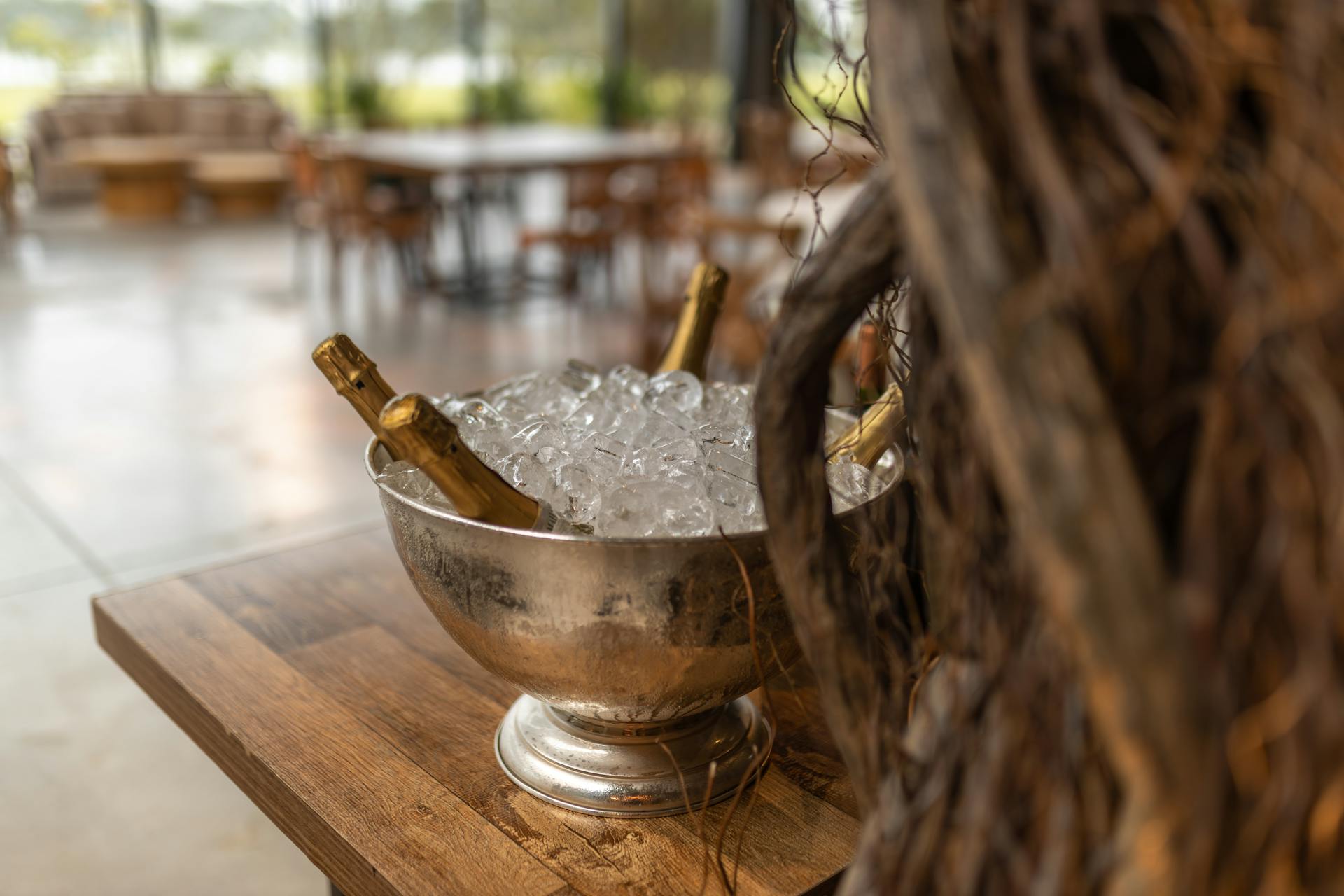 A silver bowl with champagne bottles nestled in ice, perfect for celebrations.