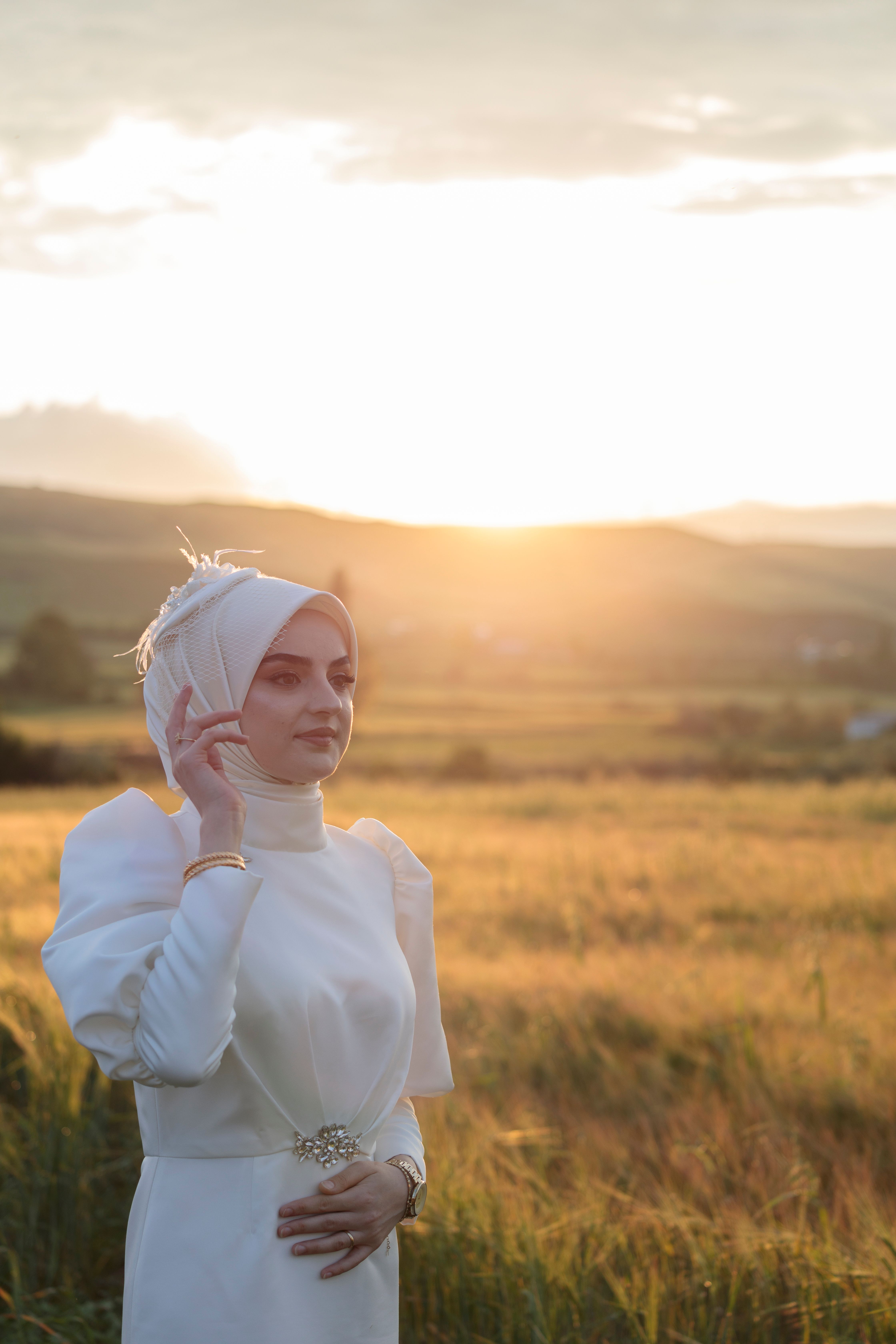Woman in Hijab and White Clothes Posing at Sunset · Free Stock Photo