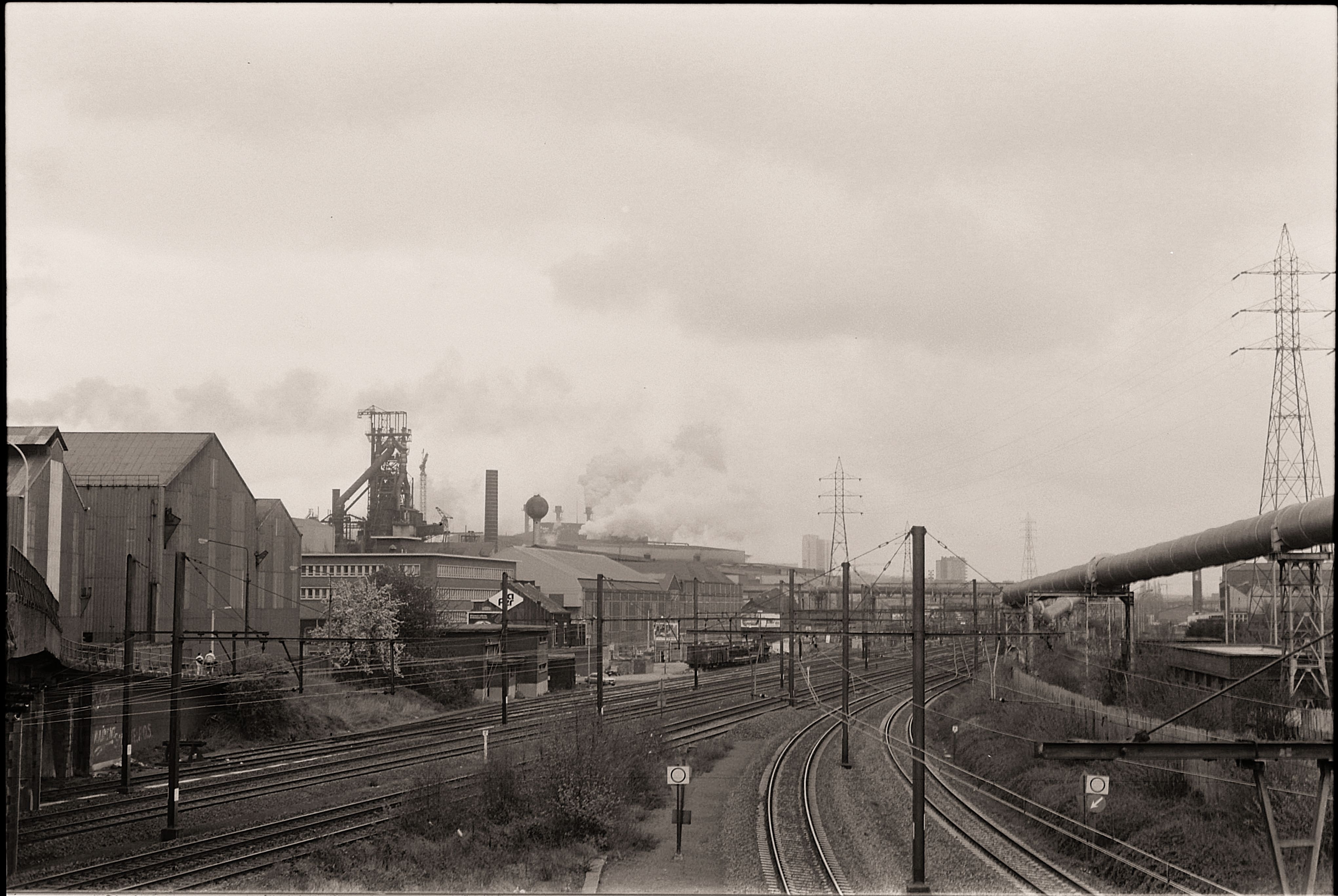 A nostalgic black and white image of industrial railways and factories.