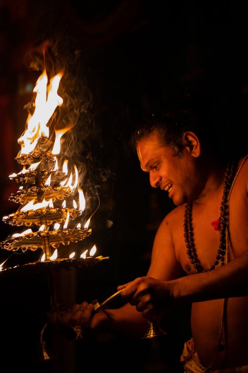 Topless Man Performing Ritual with Fire