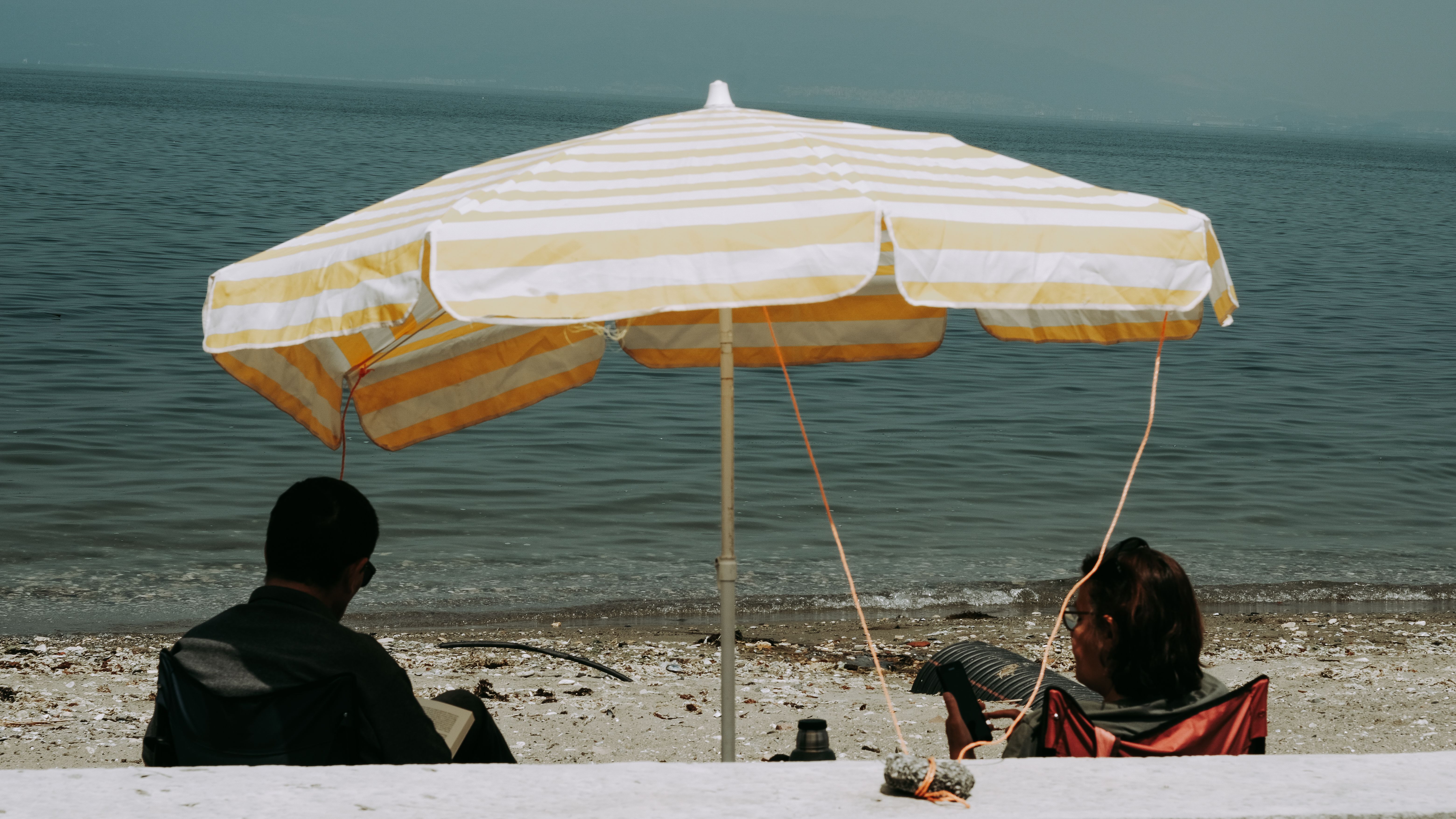 Couple under an umbrella on the beach