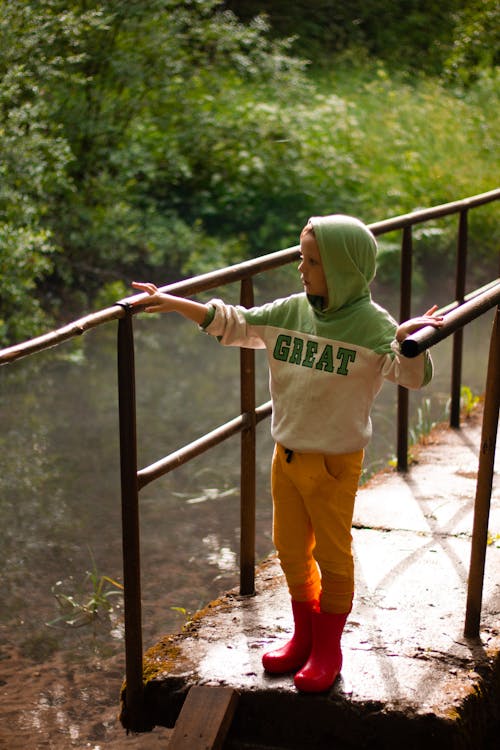 Boy in Hoodie on Footbridge