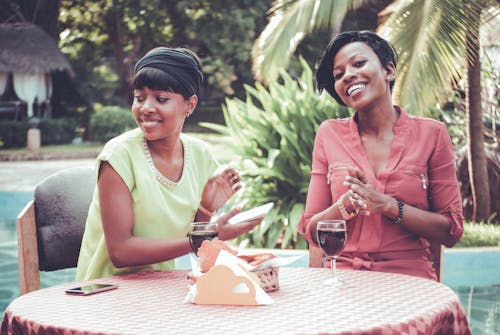 Women Sitting in Front of Table