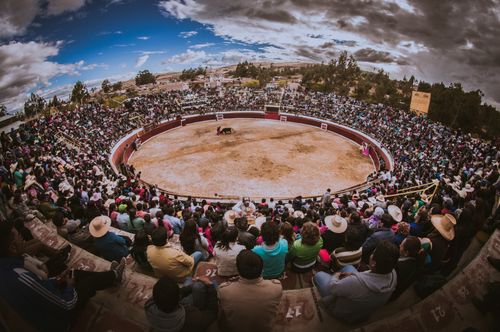 Free Crowds gather at Cajamarca, Peru, for a traditional bullfighting event, showcasing vibrant culture and tradition. Stock Photo