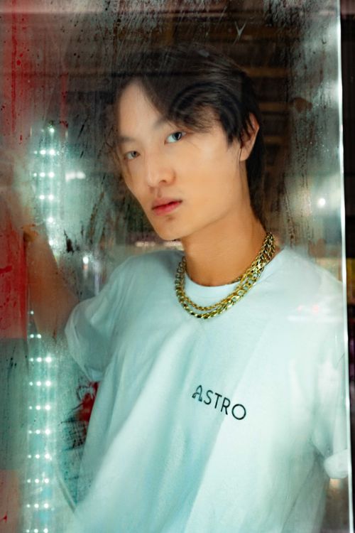 Free Portrait of a young East Asian man with a golden chain, posing confidently indoors. Stock Photo