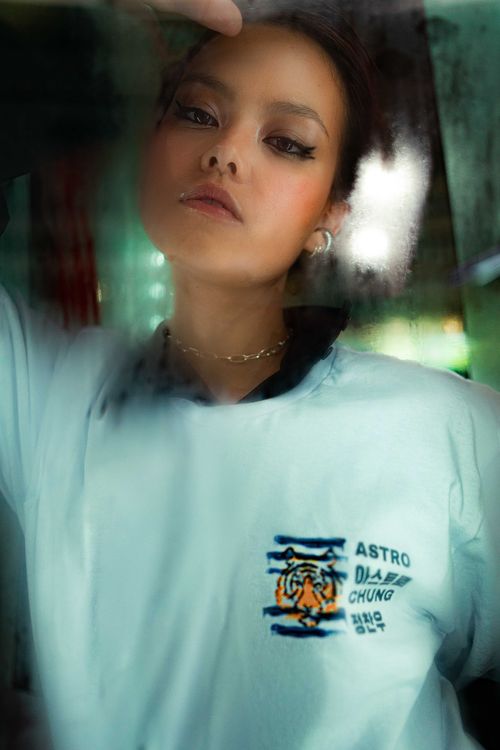 Free Moody portrait of a stylish young woman with a white t-shirt, defocused background. Stock Photo