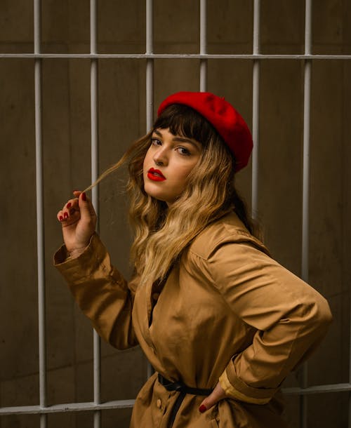 Young Woman Wearing a Trench Coat and a Red Beret 