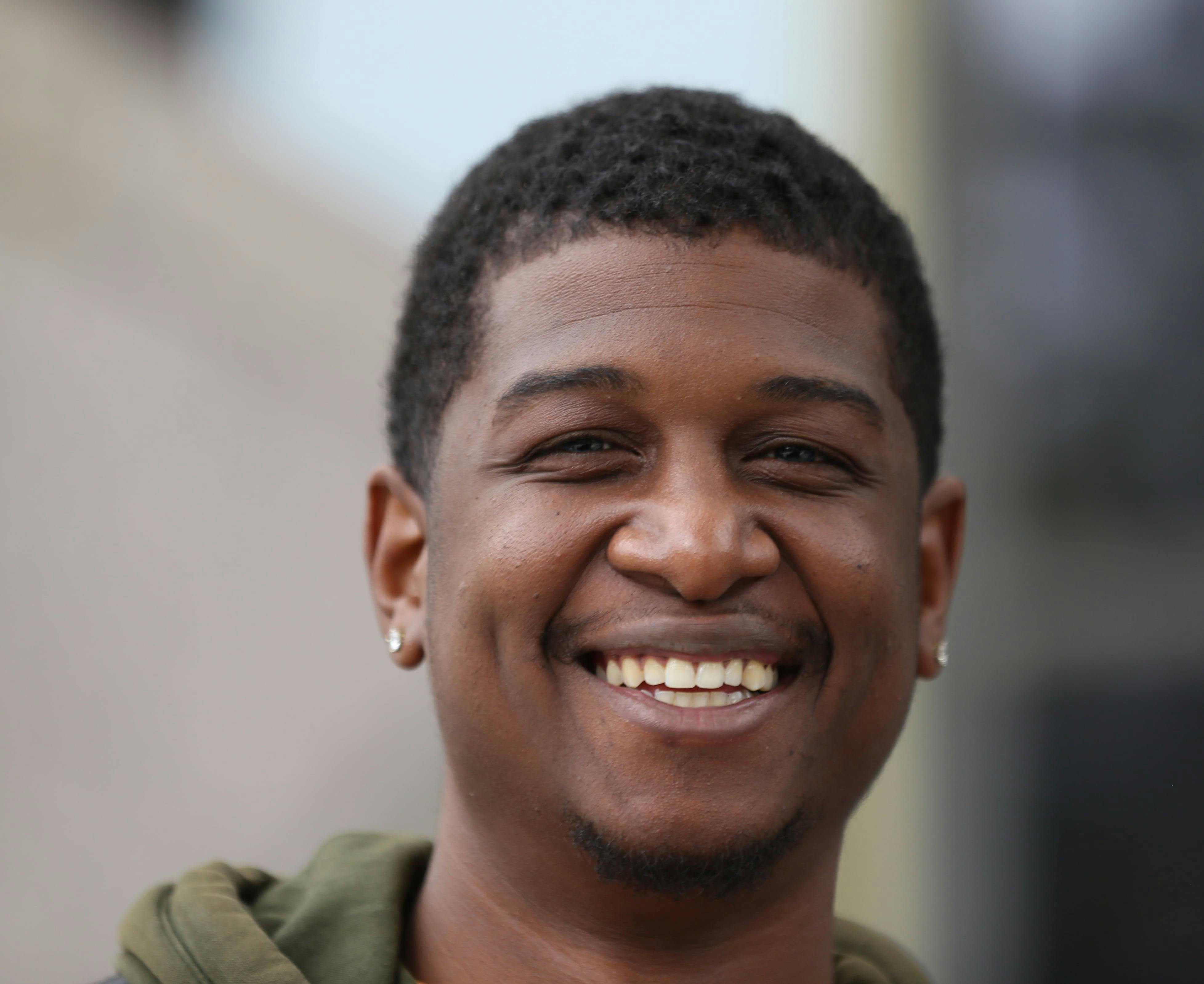 Two Young Men Standing Back to Back and Smiling · Free Stock Photo