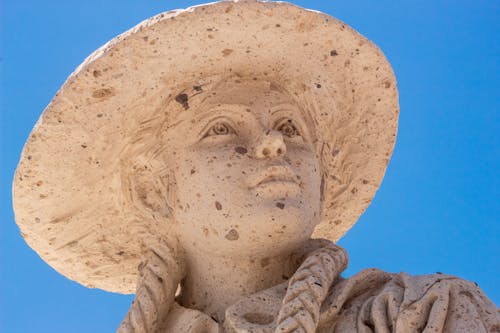 Close-up of a Sculpture of a Girl in a Hat 