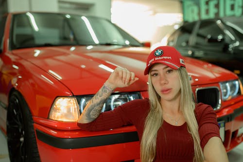 Young Woman Posing next to a Red BMW E36 in the Garage 