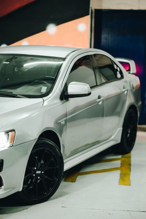 Free Luxurious white sports car parked in a stylish indoor garage setting. Stock Photo