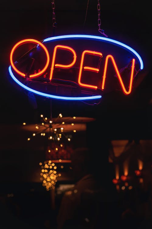 Oval Blue and Orange Open Neon Signage Turned-on