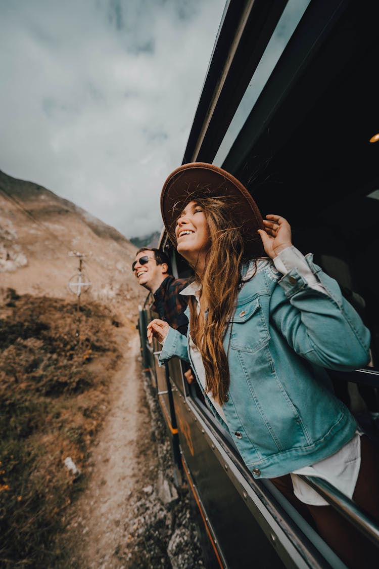 Woman Leaning Out Of A Train Window And Smiling 