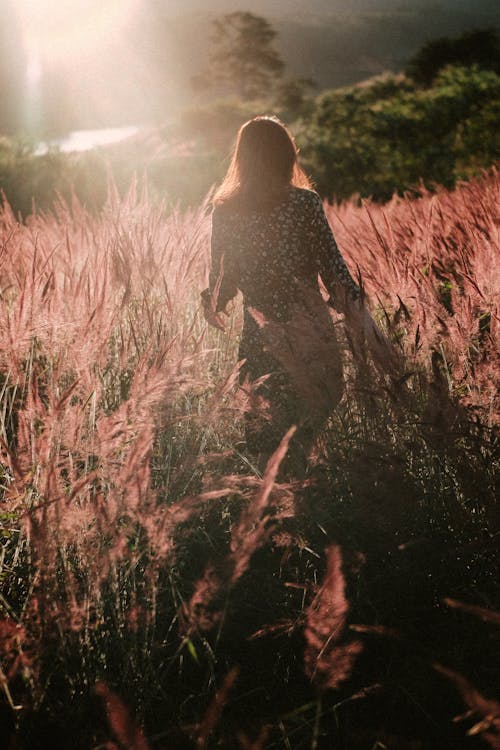 Woman Walking on Grass Area