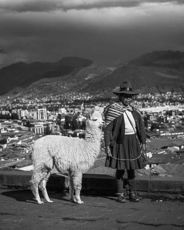 Man in Traditional Clothing with Llama